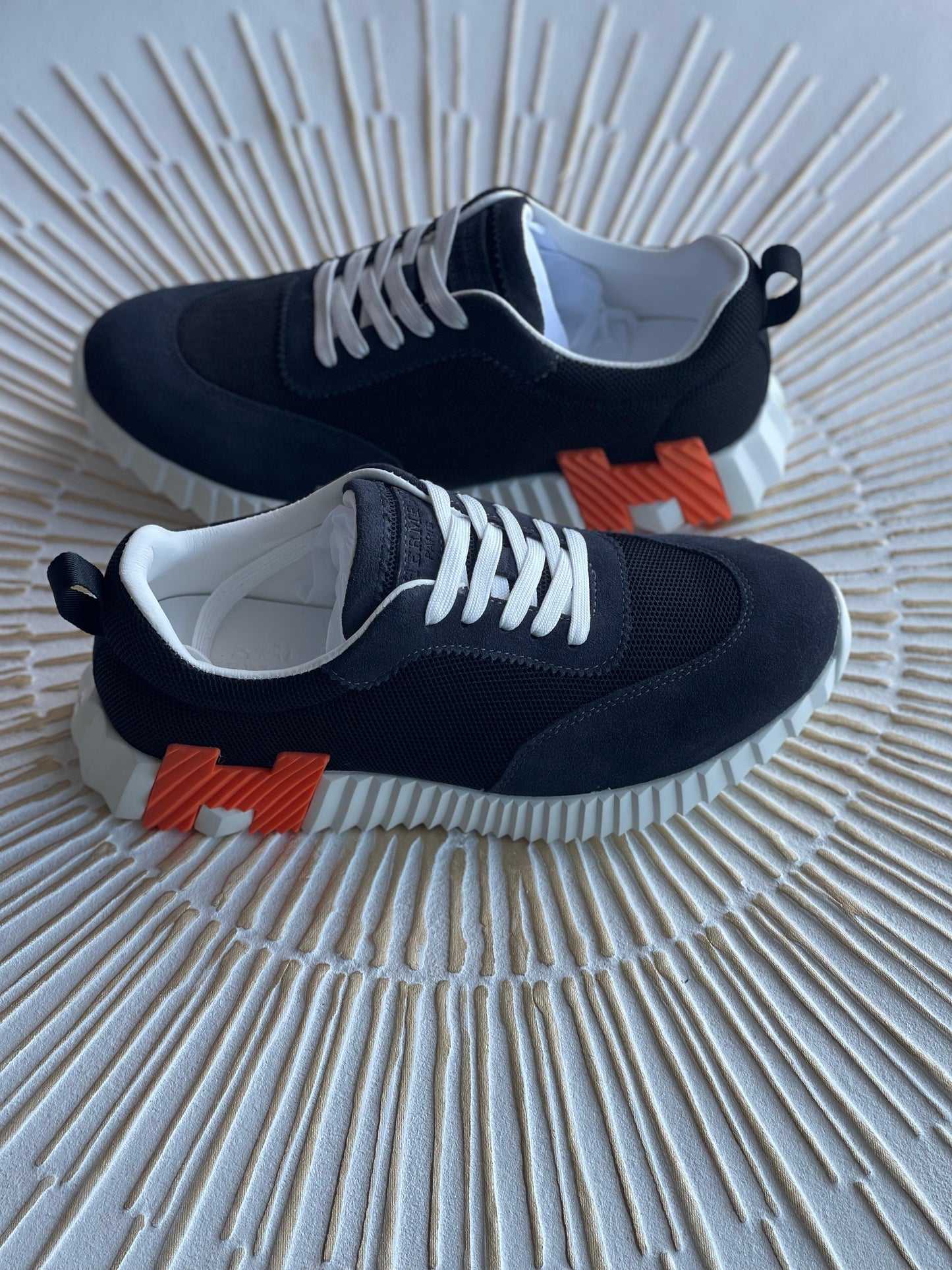 Hermès Bouncing Sneaker – Black Leather with Orange “H en biais” Detail