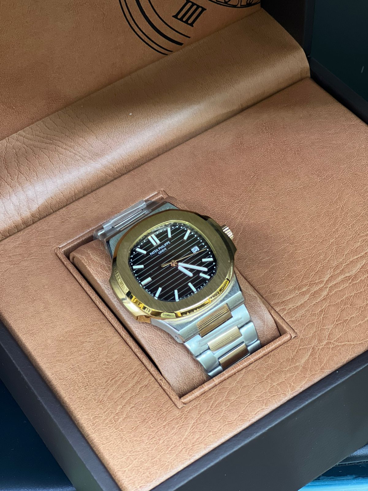 Patek Philippe Nautilus Watch with a Two-tone Case and Bracelet and a dark Dial